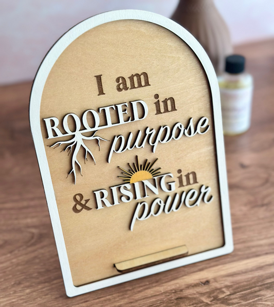 Wooden plaque with motivational quote on a wooden surface