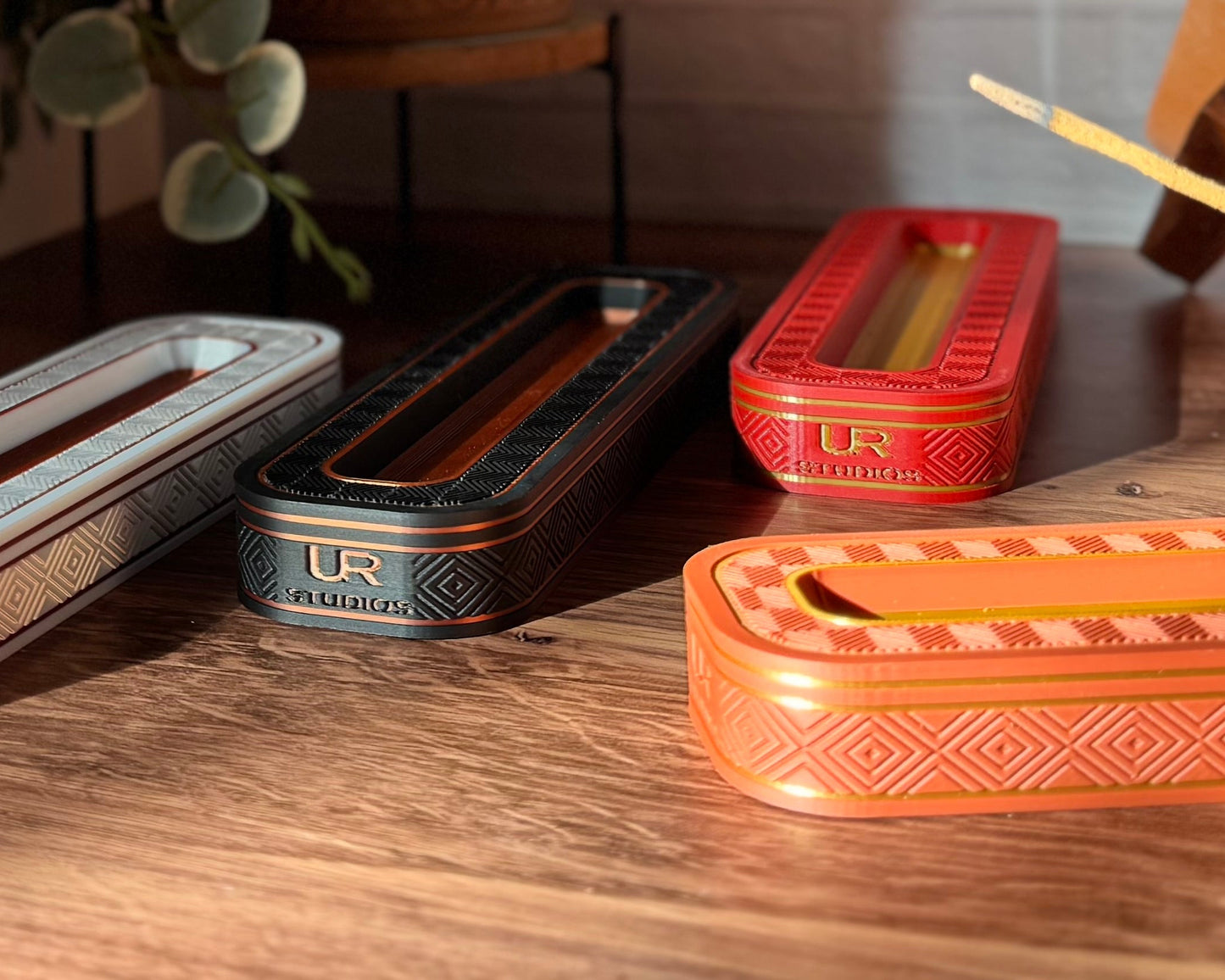 Set of decorative boxes with unique patterns on a wooden surface