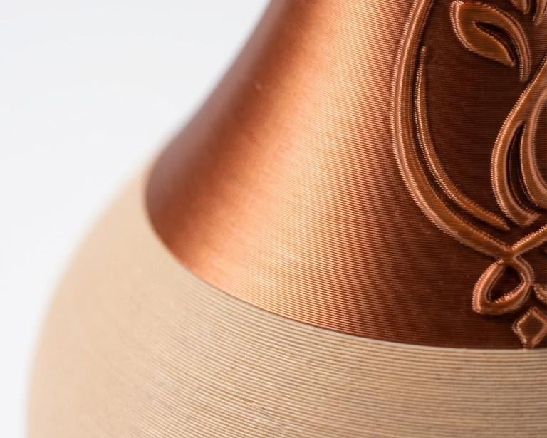 Ceramic vase with copper accents on a white background